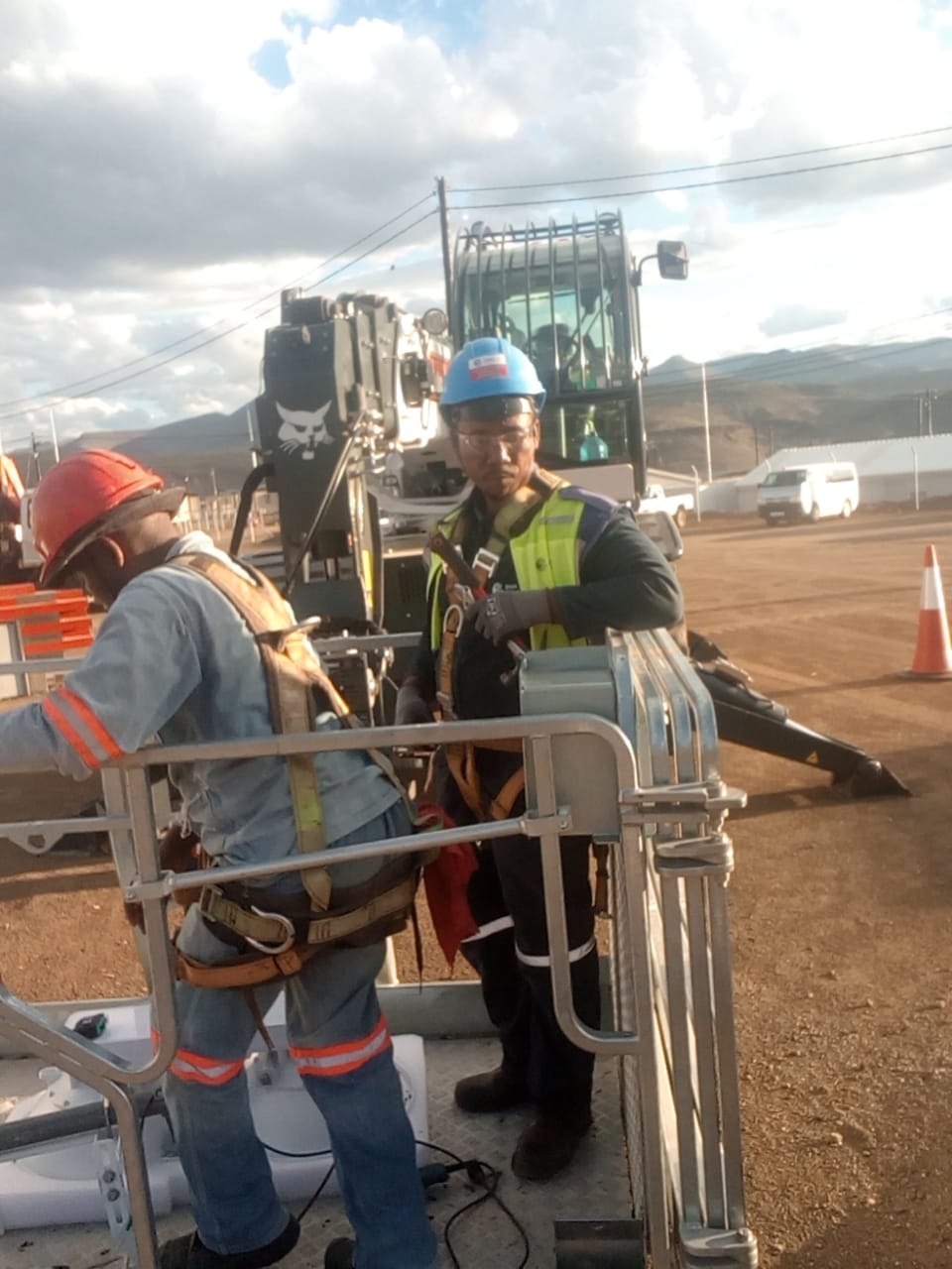 Global IT Systems crew installing network infrastructure on-site in full PPE